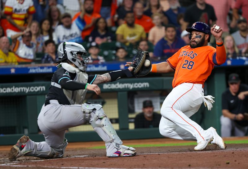 Sep 6, 2024; Houston, Texas, USA;  Houston Astros first baseman Jon Singleton (28) is tagged out by Arizona Diamondbacks catcher Jose Herrera (11) at home plate in the second inning at Minute Maid Park. Mandatory Credit: Thomas Shea-Imagn Images