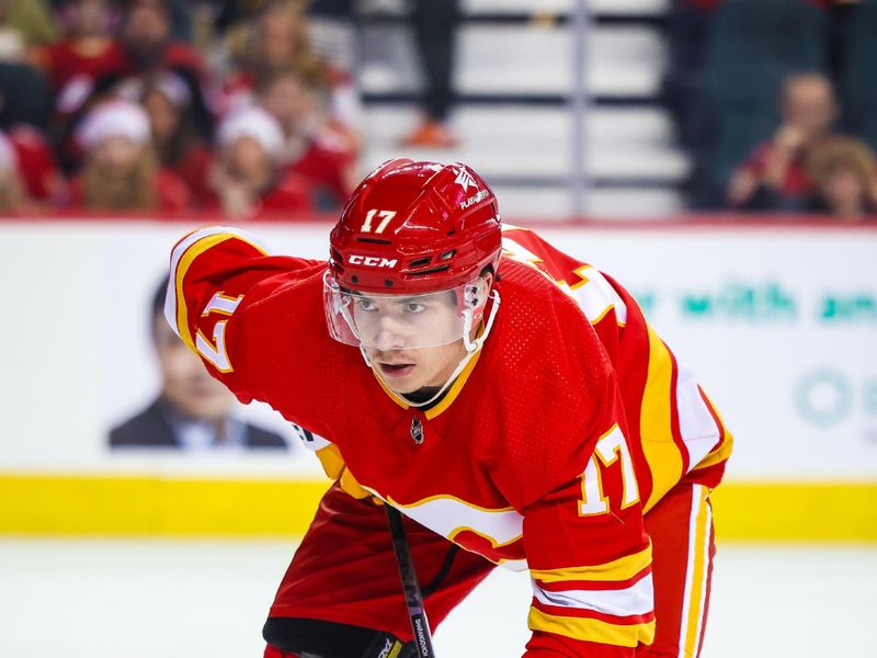 Dec 27, 2023; Calgary, Alberta, CAN; Calgary Flames center Yegor Sharangovich (17) during the face off against the Seattle Kraken during the second period at Scotiabank Saddledome. Mandatory Credit: Sergei Belski-USA TODAY Sports