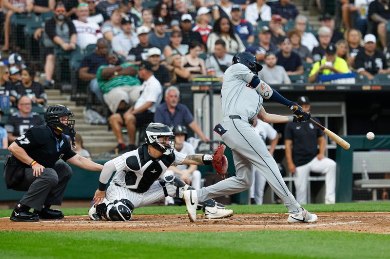 Aug 24, 2024; Chicago, Illinois, USA; Detroit Tigers outfielder Parker Meadows (22) hits an RBI-single against the Chicago White Sox during the third inning at Guaranteed Rate Field. Mandatory Credit: Kamil Krzaczynski-USA TODAY Sports