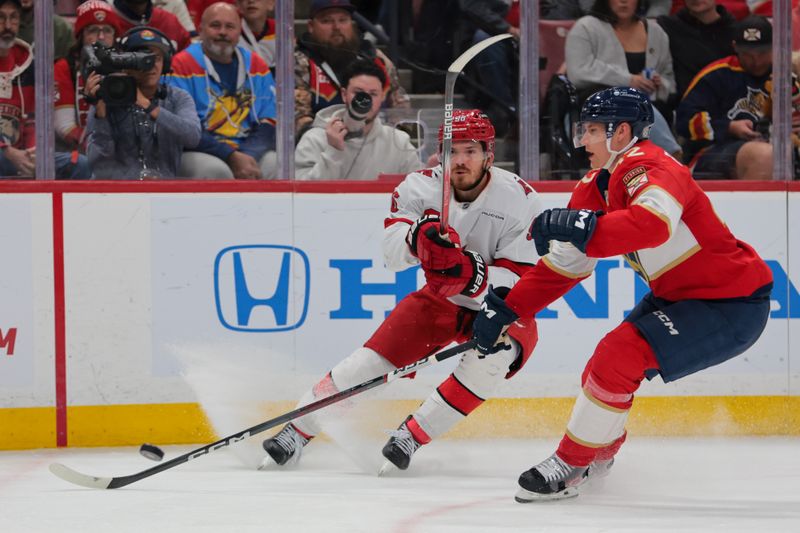 Nov 30, 2024; Sunrise, Florida, USA; Carolina Hurricanes center Jack Roslovic (96) shoots the puck against the Florida Panthers during the third period at Amerant Bank Arena. Mandatory Credit: Sam Navarro-Imagn Images