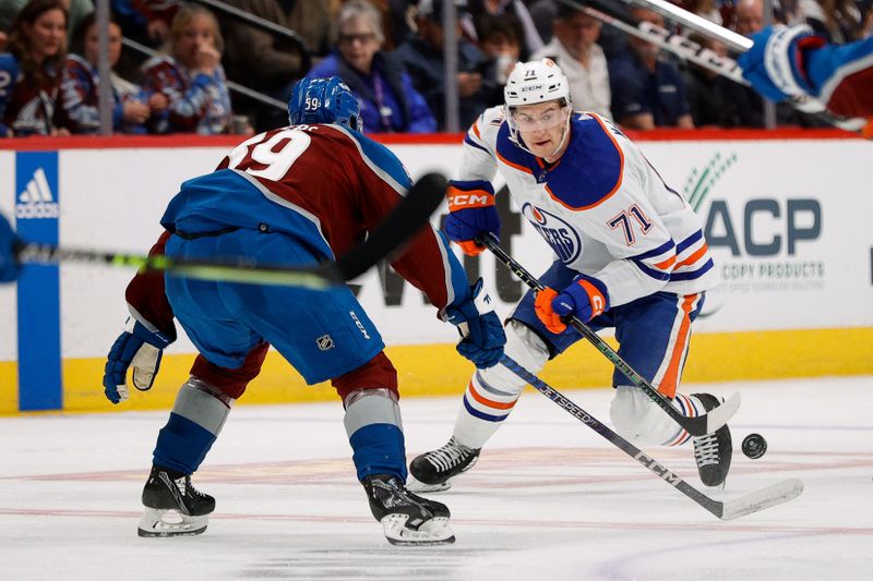 Apr 11, 2023; Denver, Colorado, USA; Edmonton Oilers center Ryan McLeod (71) controls the puck as Colorado Avalanche center Ben Meyers (59) defends in the third period at Ball Arena. Mandatory Credit: Isaiah J. Downing-USA TODAY Sports