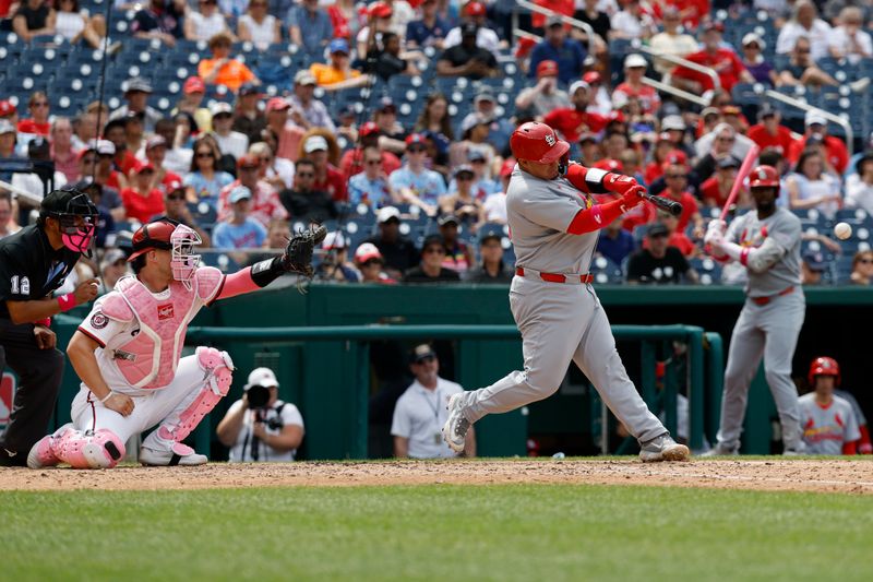 May 11, 2025; Washington, District of Columbia, USA; St. Louis Cardinals catcher Yohel Pozo (63) hits an RBI single against the Washington Nationals during the seventh inning at Nationals Park. Mandatory Credit: Geoff Burke-Imagn Images