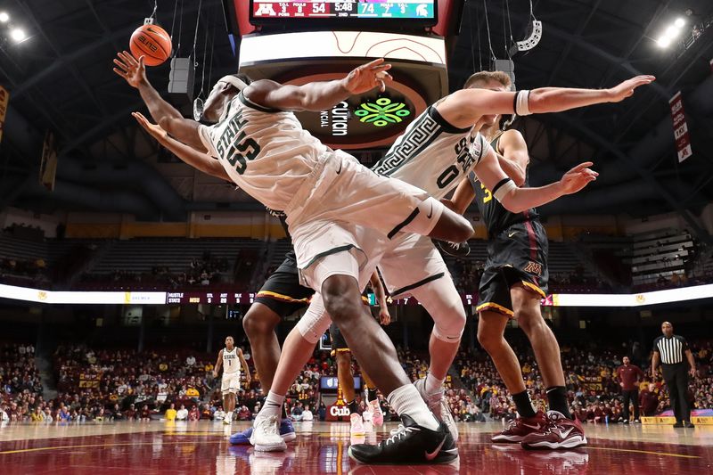 Dec 4, 2024; Minneapolis, Minnesota, USA; Michigan State Spartans forward Coen Carr (55) and forward Jaxon Kohler (0) jump for the ball during the second half against the Minnesota Golden Gophers at Williams Arena. Mandatory Credit: Matt Krohn-Imagn Images