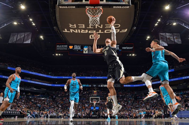 PHOENIX, AZ - MARCH 14: Brook Lopez #11 of the Milwaukee Bucks drives to the basket against the Phoenix Suns on March 14, 20223at Footprint Center in Phoenix, Arizona. NOTE TO USER: User expressly acknowledges and agrees that, by downloading and or using this photograph, user is consenting to the terms and conditions of the Getty Images License Agreement. Mandatory Copyright Notice: Copyright 2023 NBAE (Photo by Barry Gossage/NBAE via Getty Images)