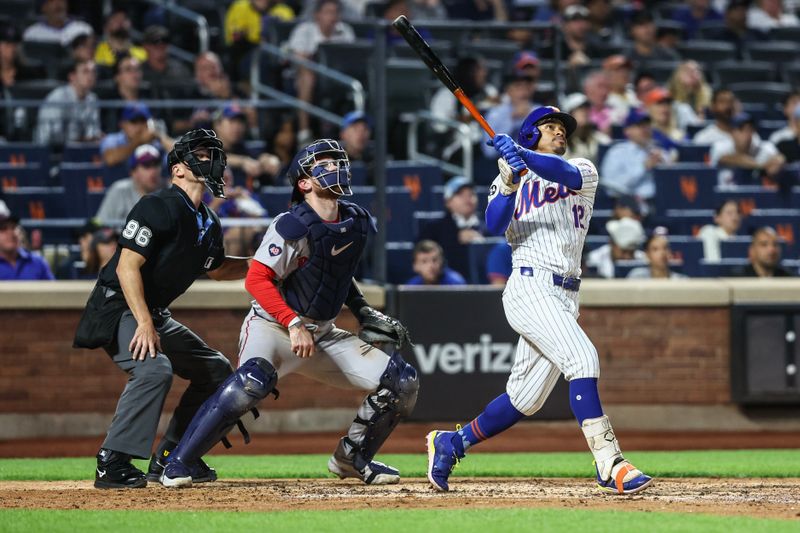 Sep 3, 2024; New York City, New York, USA;  New York Mets shortstop Francisco Lindor (12) hits a two-run home run in the third inning against the Boston Red Sox at Citi Field. Mandatory Credit: Wendell Cruz-Imagn Images