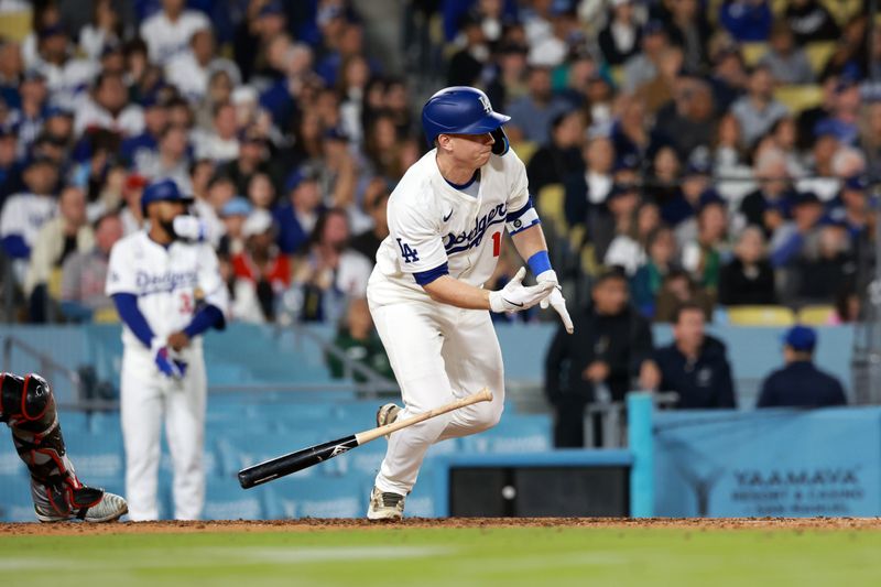 May 17, 2024; Los Angeles, California, USA;  Los Angeles Dodgers catcher Will Smith (16) hits an RBI single during the seventh inning against the Cincinnati Reds at Dodger Stadium. Mandatory Credit: Kiyoshi Mio-USA TODAY Sports