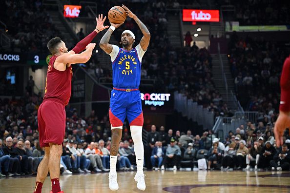 CLEVELAND, OHIO - NOVEMBER 19: Kentavious Caldwell-Pope #5 of the Denver Nuggets shoots over Max Strus #1 of the Cleveland Cavaliers during the second quarter at Rocket Mortgage Fieldhouse on November 19, 2023 in Cleveland, Ohio. NOTE TO USER: User expressly acknowledges and agrees that, by downloading and or using this photograph, User is consenting to the terms and conditions of the Getty Images License Agreement. (Photo by Jason Miller/Getty Images)