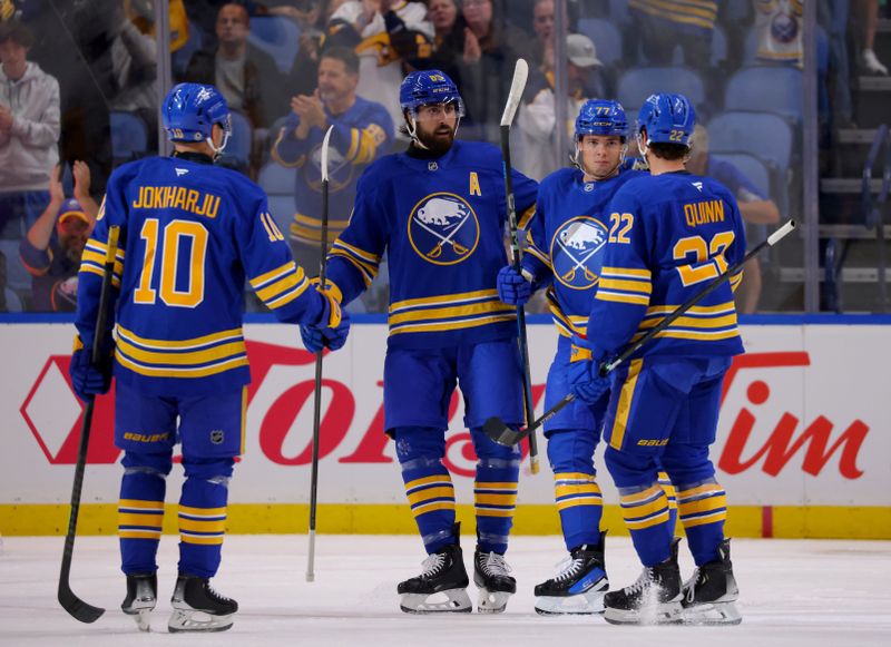 Sep 21, 2024; Buffalo, New York, USA;  Buffalo Sabres right wing JJ Peterka (77) celebrates his goal with teammates during the first period against the Pittsburgh Penguins at KeyBank Center. Mandatory Credit: Timothy T. Ludwig-Imagn Images