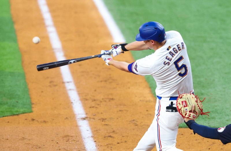 May 14, 2024; Arlington, Texas, USA;  Texas Rangers shortstop Corey Seager (5) hits a home run during the third inning against the Cleveland Guardians at Globe Life Field. Mandatory Credit: Kevin Jairaj-USA TODAY Sports