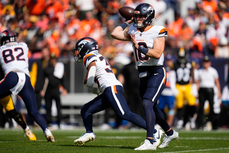 Denver Broncos quarterback Bo Nix (10) throws during the first half of an NFL football game against the Pittsburgh Steelers, Sunday, Sept. 15, 2024, in Denver. (AP Photo/Jack Dempsey)