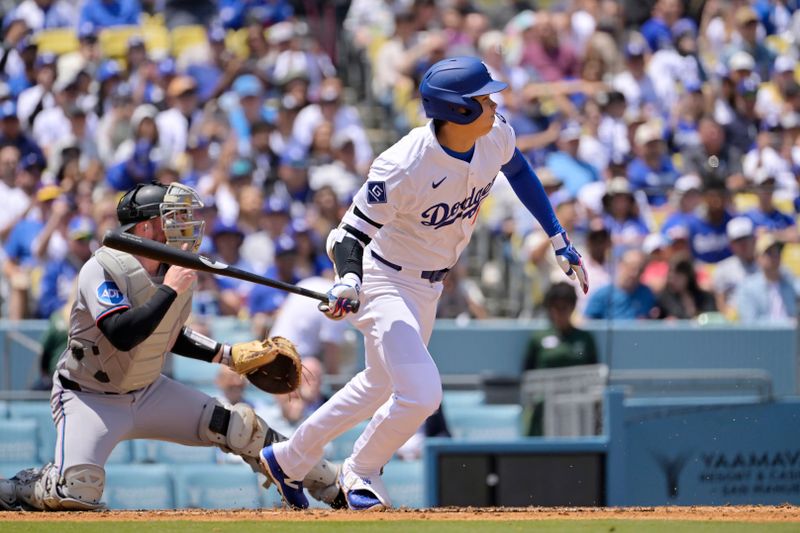 Apr 30, 2025; Los Angeles, California, USA; Los Angeles Dodgers designated hitter Shohei Ohtani (17) hits into a fielder's choice to reach first base against the Miami Marlins at Dodger Stadium. Mandatory Credit: Jayne Kamin-Oncea-Imagn Images