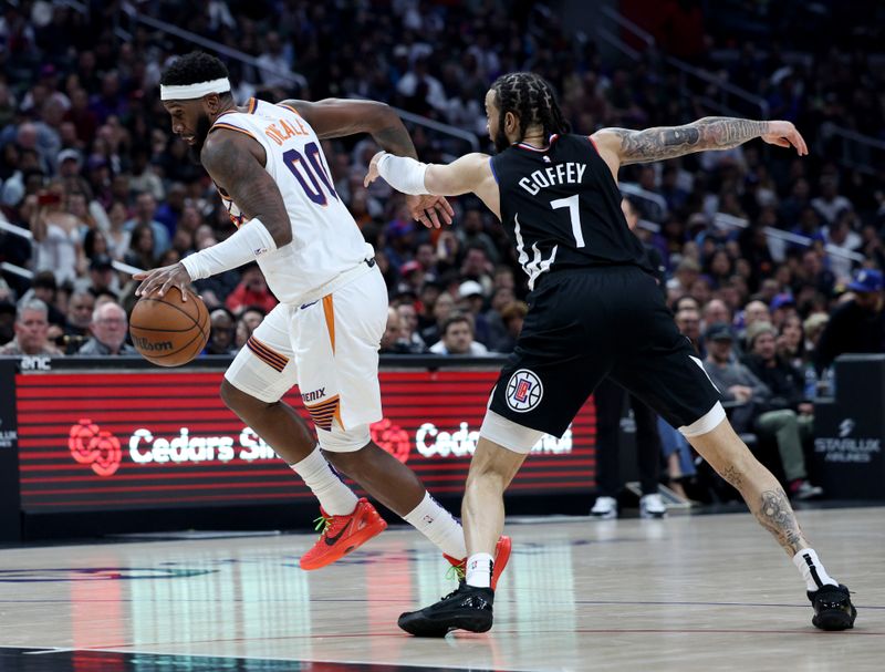 LOS ANGELES, CALIFORNIA - APRIL 10: Royce O'Neale #00 of the Phoenix Suns is fouled by Amir Coffey #7 of the LA Clippers during a 124-108 Suns win at Crypto.com Arena on April 10, 2024 in Los Angeles, California. User is consenting to the terms and conditions of the Getty Images License Agreement.  (Photo by Harry How/Getty Images)