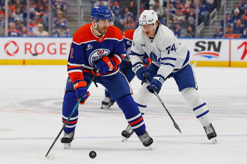 Feb 3, 2026; Edmonton, Alberta, CAN; Edmonton Oilers defensemen Evan Bouchard (2) looks to make a pass in front of Toronto Maple Leafs forward Bobby McMann (74) during the first period at Rogers Place. Mandatory Credit: Perry Nelson-Imagn Images