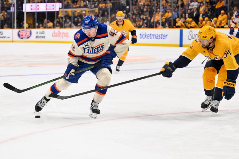 Jan 13, 2026; Nashville, Tennessee, USA;  Edmonton Oilers right wing Kasperi Kapanen (42) skates as Nashville Predators defenseman Roman Josi (59) pokes at the puck during the second period at Bridgestone Arena. Mandatory Credit: Steve Roberts-Imagn Images