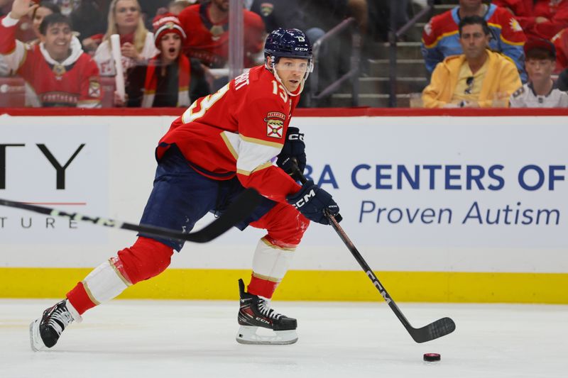 Apr 21, 2024; Sunrise, Florida, USA; Florida Panthers center Sam Reinhart (13) moves the puck against the Tampa Bay Lightning during the first period in game one of the first round of the 2024 Stanley Cup Playoffs at Amerant Bank Arena. Mandatory Credit: Sam Navarro-USA TODAY Sports