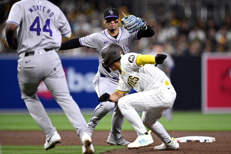 May 13, 2024; San Diego, California, USA; Colorado Rockies shortstop Ezequiel Tovar (14) pursues San Diego Padres shortstop Ha-Seong Kim (7) after being caught in a rundown during the fifth inning at Petco Park. Mandatory Credit: Orlando Ramirez-USA TODAY Sports