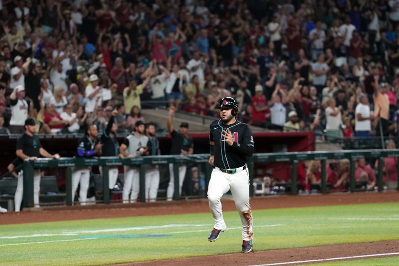 Jul 12, 2024; Phoenix, Arizona, USA; Arizona Diamondbacks third base Eugenio Suárez (28) scores a run against the Toronto Blue Jays during the eighth inning at Chase Field. Mandatory Credit: Joe Camporeale-USA TODAY Sports