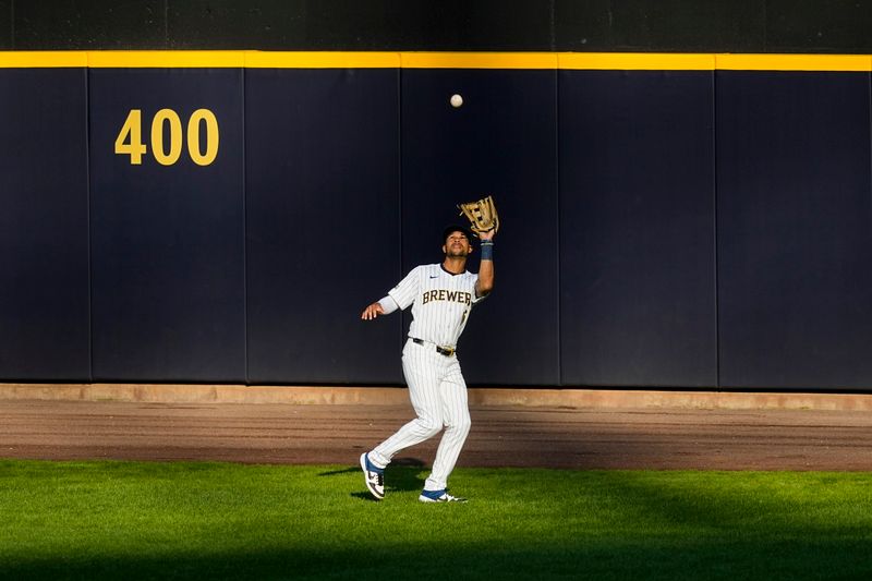 Jul 27, 2024; Milwaukee, Wisconsin, USA;  Milwaukee Brewers center fielder Blake Perkins (16) catches a fly ball during the second inning against the Miami Marlins at American Family Field. Mandatory Credit: Jeff Hanisch-USA TODAY Sports
