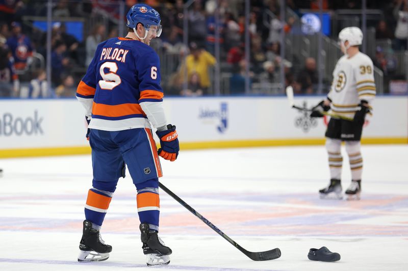 Mar 2, 2024; Elmont, New York, USA; New York Islanders defenseman Ryan Pulock (6) reacts after a fan threw a shoe onto the ice after a natural hat trick by center Kyle Palmieri (not pictured) during the first period against the Boston Bruins at UBS Arena. Mandatory Credit: Brad Penner-USA TODAY Sports