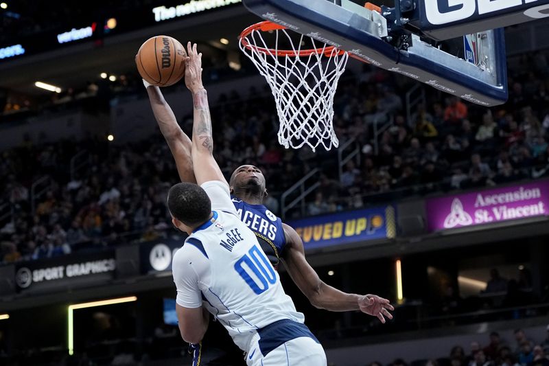 INDIANAPOLIS, INDIANA - MARCH 27: JaVale McGee #00 of the Dallas Mavericks blocks a dunk attempt by Aaron Nesmith #23 of the Indiana Pacers in the fourth quarter at Gainbridge Fieldhouse on March 27, 2023 in Indianapolis, Indiana. NOTE TO USER: User expressly acknowledges and agrees that, by downloading and or using this photograph, User is consenting to the terms and conditions of the Getty Images License Agreement. (Photo by Dylan Buell/Getty Images)