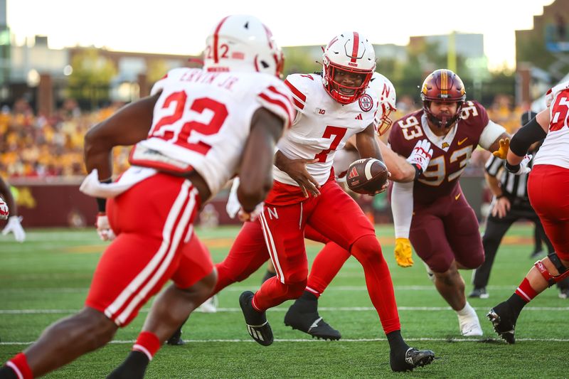 Aug 31, 2023; Minneapolis, Minnesota, USA; Nebraska Cornhuskers quarterback Jeff Sims (7) hands the ball off to running back Gabe Ervin Jr. (22) against the Minnesota Golden Gophers during the first quarter at Huntington Bank Stadium. Mandatory Credit: Matt Krohn-USA TODAY Sports