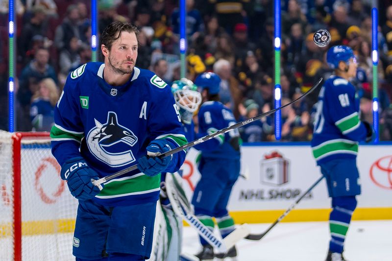Dec 14, 2024; Vancouver, British Columbia, CAN; Vancouver Canucks forward J.T. Miller (9) handles the puck during warm up prior to a game against the Boston Bruins at Rogers Arena. Mandatory Credit: Bob Frid-Imagn Images