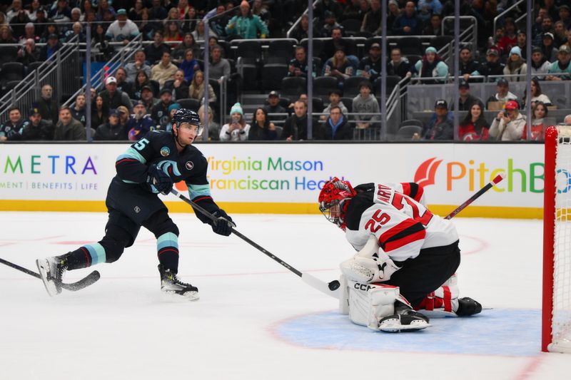 Jan 6, 2025; Seattle, Washington, USA; New Jersey Devils goaltender Jacob Markstrom (25) blocks a goal shot by Seattle Kraken left wing Andre Burakovsky (95) during the first period at Climate Pledge Arena. Mandatory Credit: Steven Bisig-Imagn Images