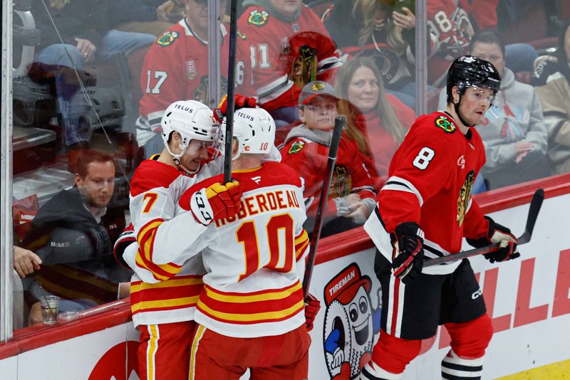 Jan 13, 2025; Chicago, Illinois, USA; Calgary Flames center Yegor Sharangovich (17) celebrates with  center Jonathan Huberdeau (10) after scoring a goal against the Chicago Blackhawks during the second period at United Center. Mandatory Credit: Kamil Krzaczynski-Imagn Images