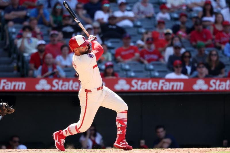 Jun 9, 2024; Anaheim, California, USA;  Los Angeles Angels right fielder Kevin Pillar (12) hits a single during the ninth inning against the Houston Astros at Angel Stadium. Mandatory Credit: Kiyoshi Mio-USA TODAY Sports