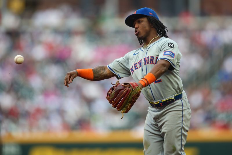 Sep 30, 2024; Atlanta, Georgia, USA; New York Mets second baseman Luisangel Acuna (2) throws a runner out at first against the Atlanta Braves in the fourth inning at Truist Park. Mandatory Credit: Brett Davis-Imagn Images