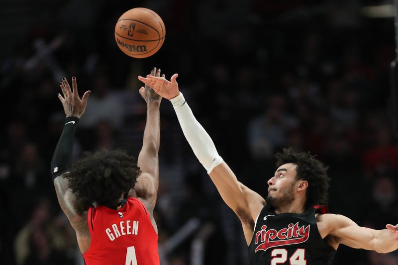 PORTLAND, OREGON - APRIL 12: Justin Minaya #24 of the Portland Trail Blazers tries to block a shot by Jalen Green #4 of the Houston Rockets during the fourth quarter at Moda Center on April 12, 2024 in Portland, Oregon. NOTE TO USER: User expressly acknowledges and agrees that, by downloading and or using this photograph, User is consenting to the terms and conditions of the Getty Images License Agreement.? (Photo by Amanda Loman/Getty Images)