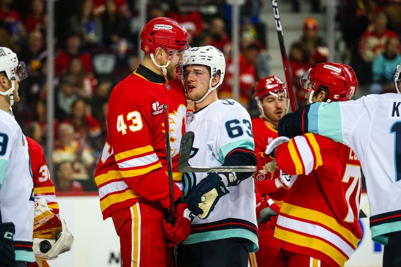 Dec 18, 2025; Calgary, Alberta, CAN; Calgary Flames right wing Adam Klapka (43) and Seattle Kraken right wing Jacob Melanson (63) exchange words during the first period at Scotiabank Saddledome. Mandatory Credit: Sergei Belski-Imagn Images