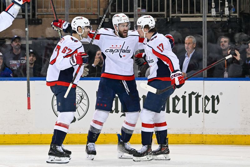 Apr 23, 2024; New York, New York, USA;  Washington Capitals right wing Tom Wilson  (43) and left wing Max Pacioretty (67) celebrate the goal by  center Dylan Strome (17) against the New York Rangers during the second period in game two of the first round of the 2024 Stanley Cup Playoffs at Madison Square Garden. Mandatory Credit: Dennis Schneidler-USA TODAY Sports