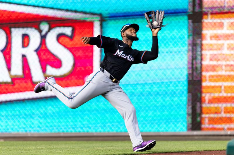 Jun 29, 2024; Philadelphia, Pennsylvania, USA; Miami Marlins outfielder Bryan De La Cruz (14) makes a running catch for an out during the sixth inning against the Philadelphia Phillies at Citizens Bank Park. Mandatory Credit: Bill Streicher-USA TODAY Sports