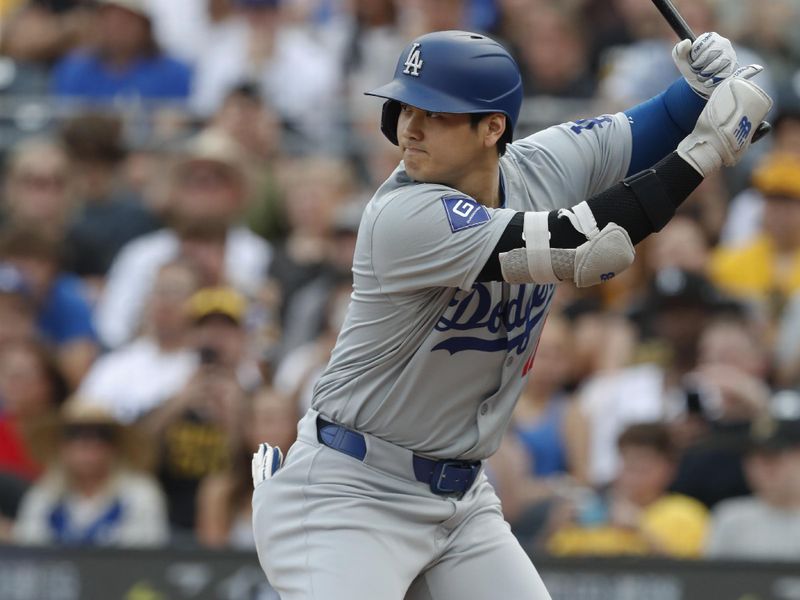 Jun 4, 2024; Pittsburgh, Pennsylvania, USA;  Los Angeles Dodgers designated hitter Shohei Ohtani (17) at bat against the Pittsburgh Pirates during the first inning at PNC Park. Mandatory Credit: Charles LeClaire-USA TODAY Sports