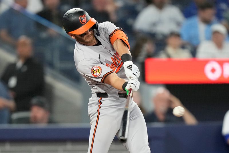 Jun 4, 2024; Toronto, Ontario, CAN;  Baltimore Orioles second baseman Connor Norby (12) hits a two-run home run against the Toronto Blue Jays during the eighth inning at Rogers Centre. Mandatory Credit: John E. Sokolowski-USA TODAY Sports