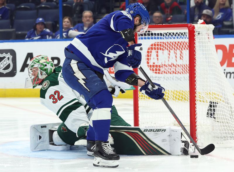 Jan 18, 2024; Tampa, Florida, USA; Tampa Bay Lightning right wing Nikita Kucherov (86) shoots as Minnesota Wild goaltender Filip Gustavsson (32) makes a save during the first period at Amalie Arena. Mandatory Credit: Kim Klement Neitzel-USA TODAY Sports