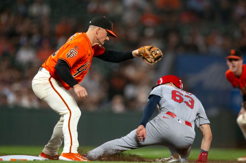 Sep 27, 2024; San Francisco, California, USA; San Francisco Giants third baseman Matt Chapman (26) tags out St. Louis Cardinals center fielder Michael Siani (63) as he tries to go from first to third during the eighth inning at Oracle Park. Mandatory Credit: D. Ross Cameron-Imagn Images