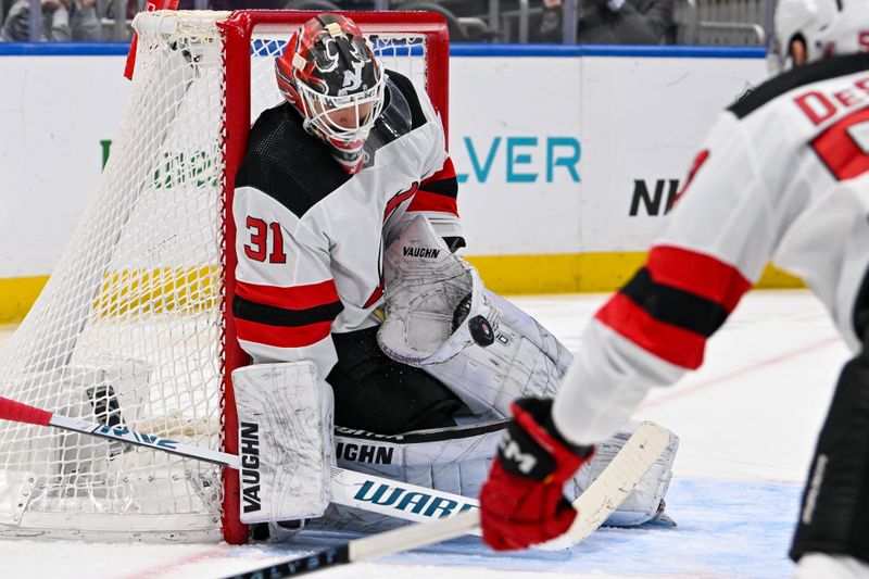 Mar 24, 2024; Elmont, New York, USA;  New Jersey Devils goaltender Kaapo Kahkonen (31) makes a save against the New York Islanders during the second period at UBS Arena. Mandatory Credit: Dennis Schneidler-USA TODAY Sports