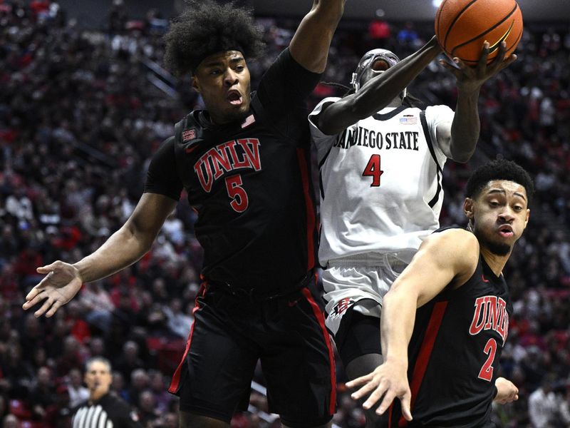 Jan 6, 2024; San Diego, California, USA; San Diego State Aztecs forward Jay Pal (4) goes to the basket defended by UNLV Rebels forward Rob Whaley Jr. (5) during the first half at Viejas Arena. Mandatory Credit: Orlando Ramirez-USA TODAY Sports