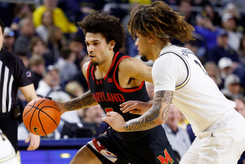 Mar 5, 2025; Ann Arbor, Michigan, USA;  Maryland Terrapins Donald Carey (0) dribbles defended by Michigan Wolverines guard Tre Donaldson (3) in the second half at Crisler Center. Mandatory Credit: Rick Osentoski-Imagn Images