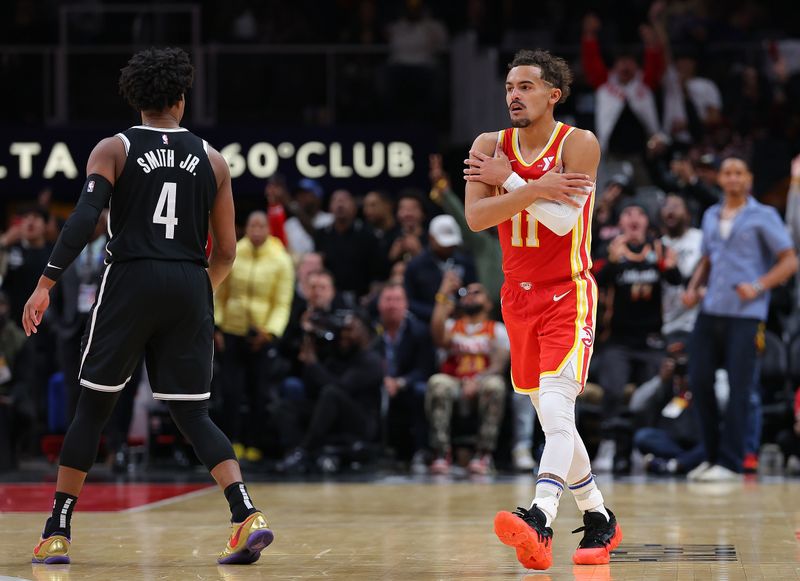 ATLANTA, GEORGIA - DECEMBER 06:  Trae Young #11 of the Atlanta Hawks reacts after a three-point basket against the Brooklyn Nets during the fourth quarter at State Farm Arena on December 06, 2023 in Atlanta, Georgia.  NOTE TO USER: User expressly acknowledges and agrees that, by downloading and/or using this photograph, user is consenting to the terms and conditions of the Getty Images License Agreement.  (Photo by Kevin C. Cox/Getty Images)