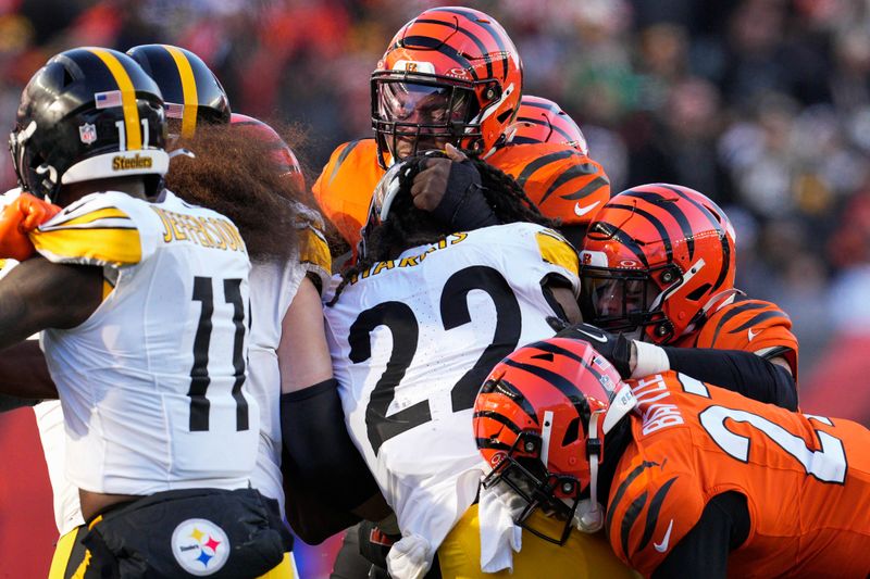 Pittsburgh Steelers running back Najee Harris (22) is tackled by Cincinnati Bengals defenders during the second half of an NFL football game Sunday, Dec. 1, 2024, in Cincinnati. (AP Photo/Jeff Dean)