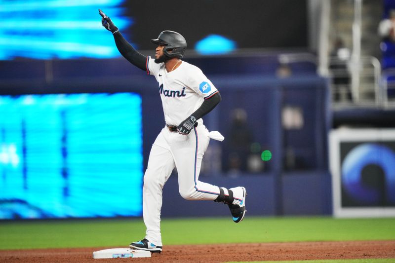 Jun 4, 2024; Miami, Florida, USA; Miami Marlins designated hitter Bryan De La Cruz (14) rounds the bases after hitting a home run against the Tampa Bay Rays in the first inning at loanDepot Park. Mandatory Credit: Jim Rassol-USA TODAY Sports