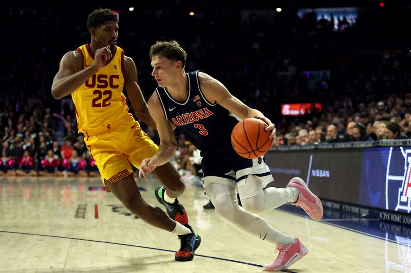 Jan 17, 2024; Tucson, Arizona, USA; Arizona Wildcats guard Pelle Larsson (3) drives to the net agaisnt USC Trojans forward Arrinten Page (22) during the second half at McKale Center. Mandatory Credit: Zachary BonDurant-USA TODAY Sports