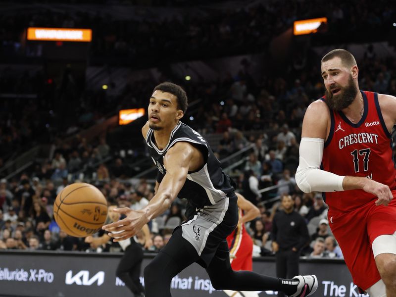 SAN ANTONIO, TX - FEBRUARY  2:  Victor Wembanyama #1 of the San Antonio Spurs chases a loose ball next to Jonas Valanciunas #17 of the New Orleans Pelicans  in the second half at Frost Bank Center on February  2, 2024 in San Antonio, Texas. NOTE TO USER: User expressly acknowledges and agrees that, by downloading and or using this photograph, User is consenting to terms and conditions of the Getty Images License Agreement. (Photo by Ronald Cortes/Getty Images)