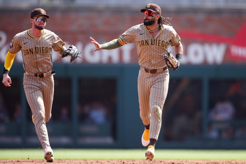 May 24, 2025; Atlanta, Georgia, USA; San Diego Padres right fielder Fernando Tatis Jr. (23) celebrates after a catch with center fielder Jackson Merrill (3) against the Atlanta Braves in the first inning at Truist Park. Mandatory Credit: Brett Davis-Imagn Images