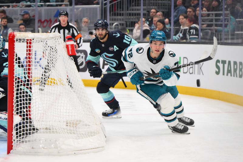 Jan 30, 2025; Seattle, Washington, USA; San Jose Sharks left wing William Eklund (72) chases a loose puck while defended by Seattle Kraken center Matty Beniers (10) during the second period at Climate Pledge Arena. Mandatory Credit: Steven Bisig-Imagn Images