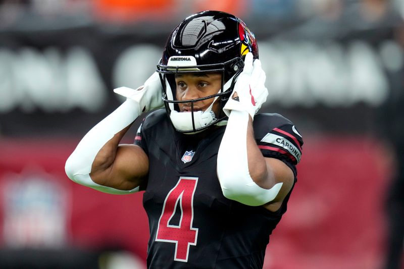 Arizona Cardinals wide receiver Rondale Moore (4) warms up prior to an NFL football game against the Cincinnati Bengals, Sunday, Oct. 8, 2023, in Glendale, Ariz. (AP Photo/Ross D. Franklin)