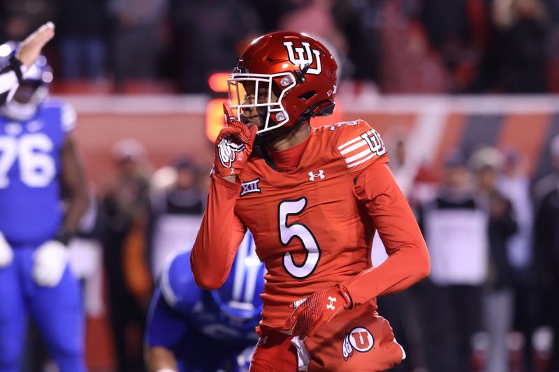 Nov 9, 2024; Salt Lake City, Utah, USA; Utah Utes cornerback Zemaiah Vaughn (5) reacts after a sack against the Brigham Young Cougars during the second half at Rice-Eccles Stadium. Mandatory Credit: Rob Gray-Imagn Images
